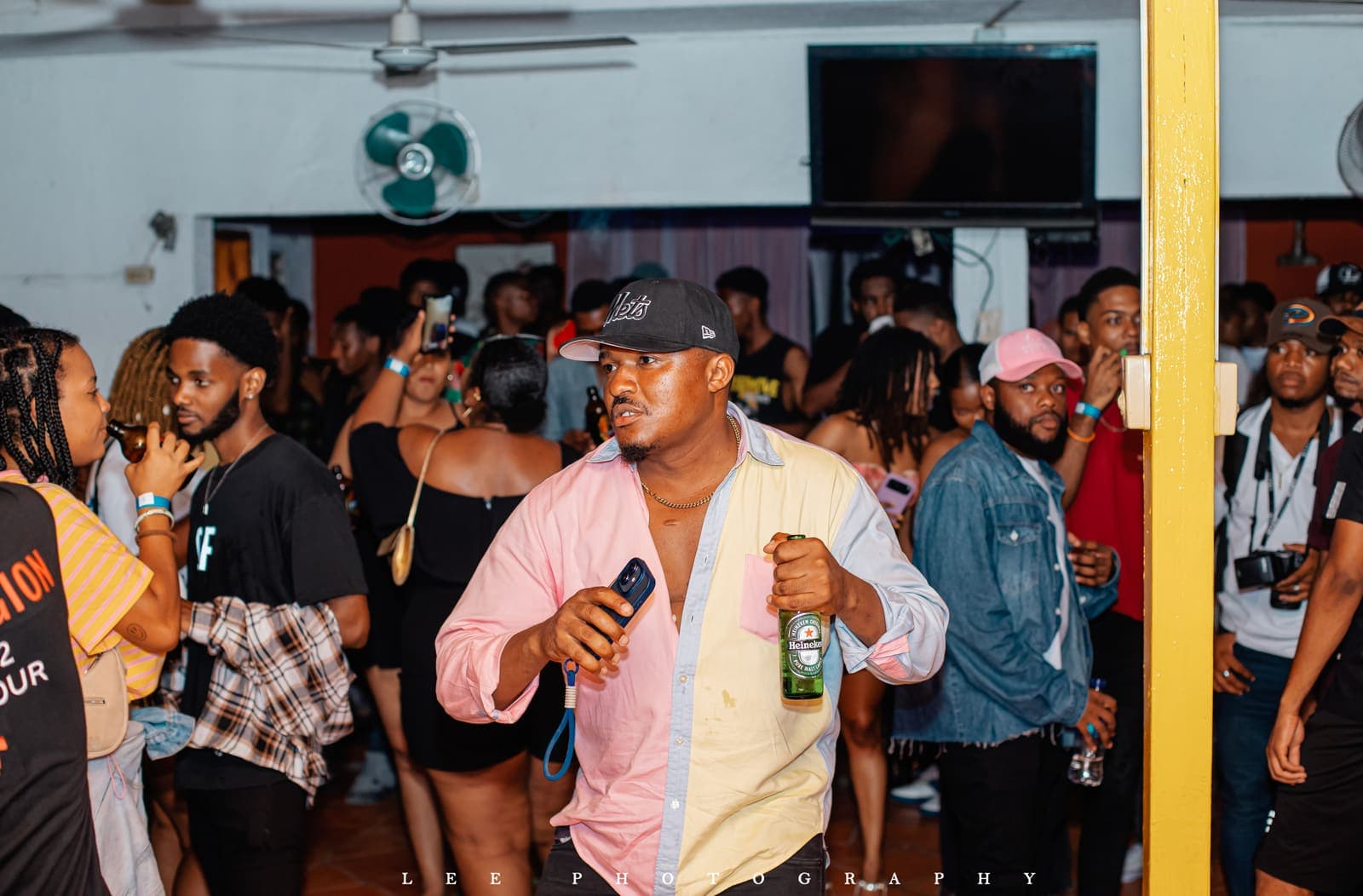 The floor at UNCUT Vol. 1 in Pétion-Ville — the room shoulder to shoulder under warm light.